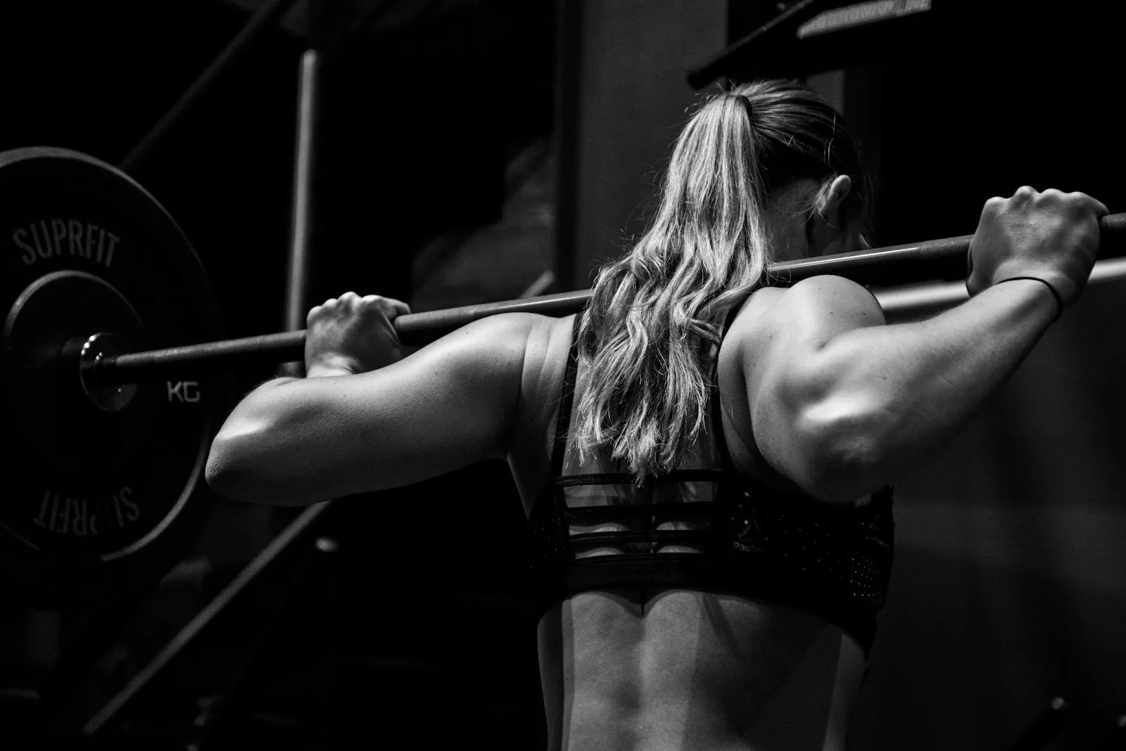Coach guiding an athlete through a gym session